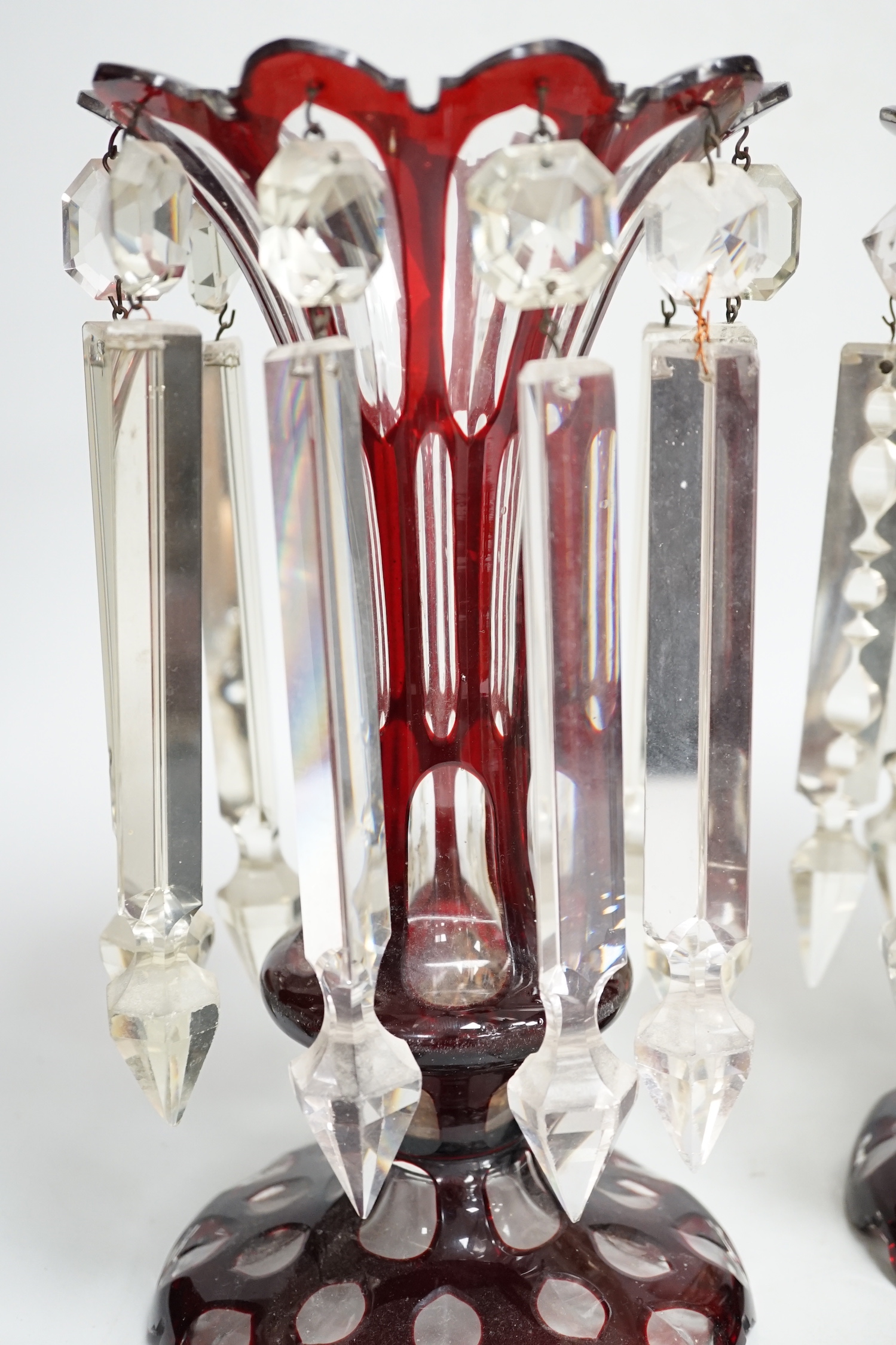 A pair of Victorian ruby overlaid glass table lustres, 28cm
